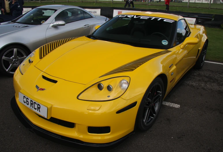 a yellow sports car in a parking space