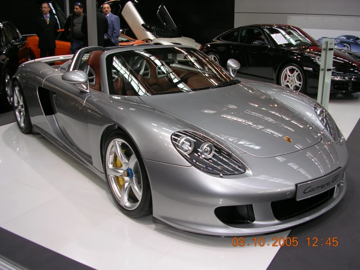 there is a silver sports car on display