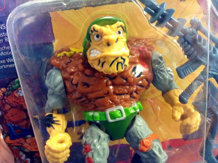 a plastic figure with large claws and red paint on his body