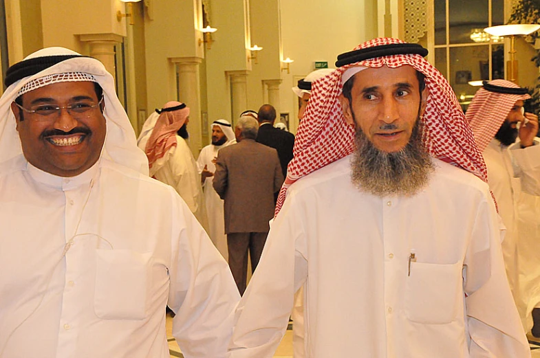 two men in formal garb standing next to each other