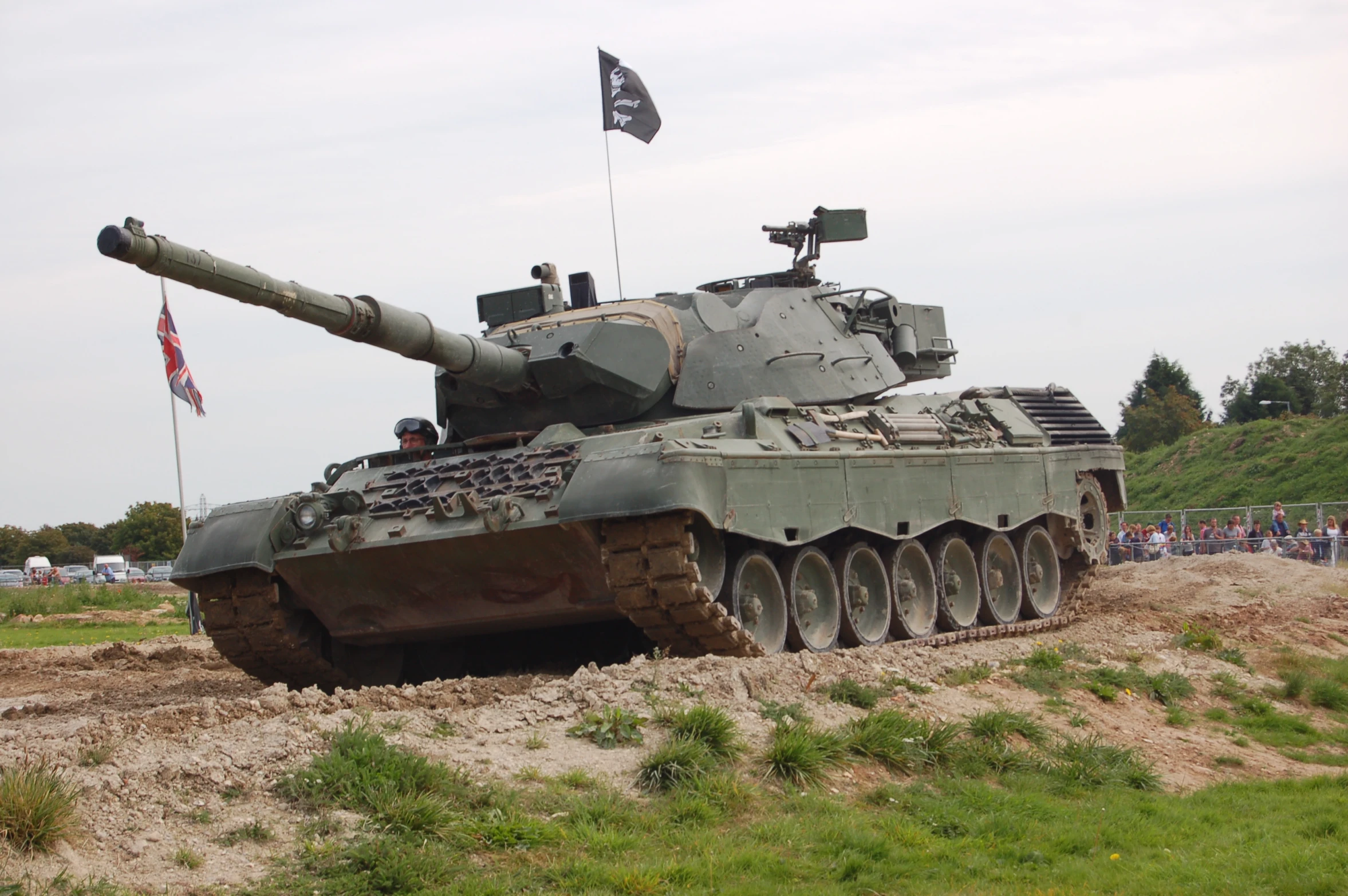 a tank with nozzle is parked in the dirt