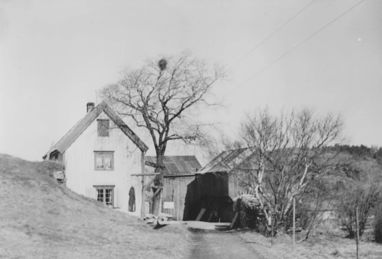 black and white pograph of a house on a hill