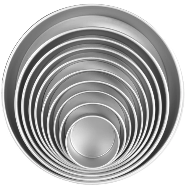 six round metal pans with a white background