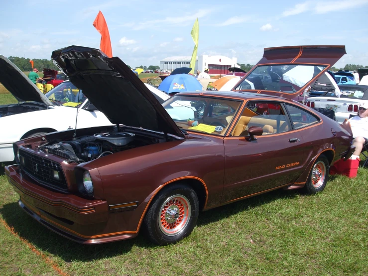 an old pontiac car with its hood open