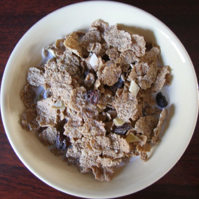 cereal in white bowl sitting on a wooden table