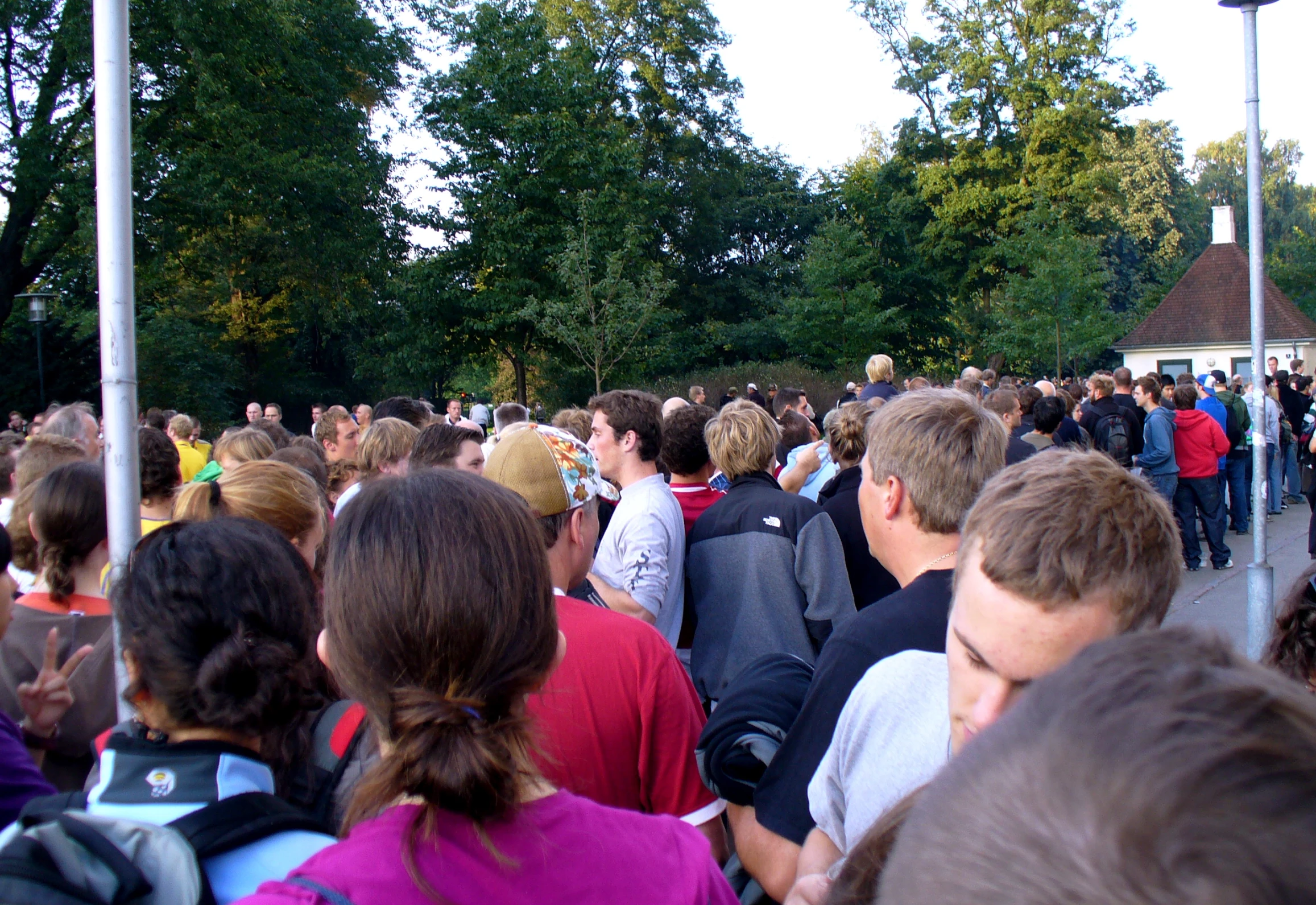 a large crowd of people walking down a street