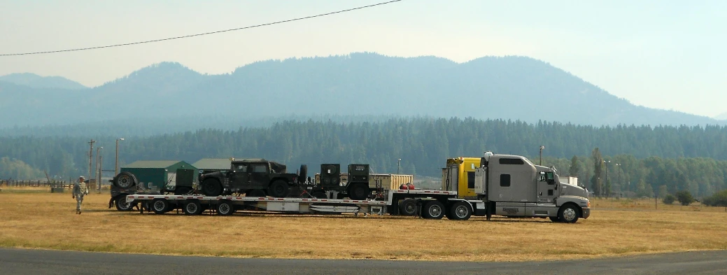 the flatbed truck is loaded with various equipment