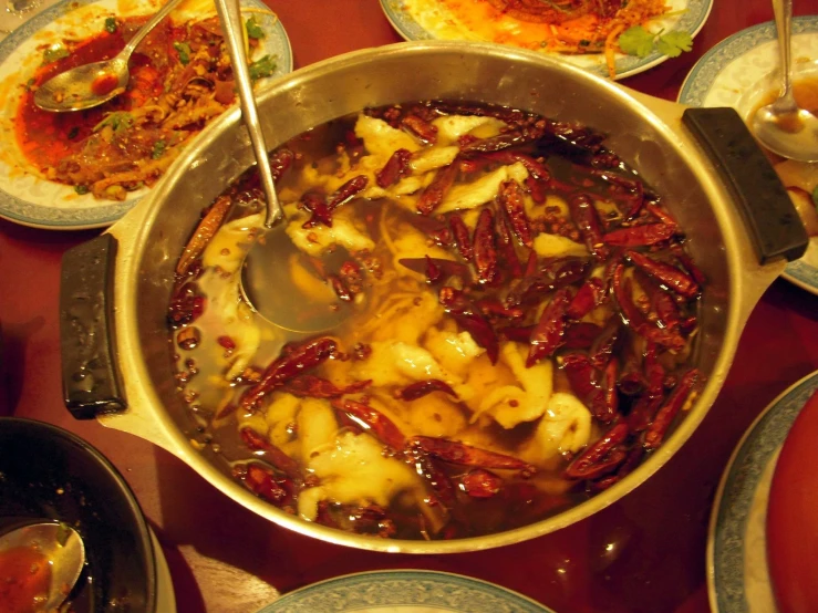 several pans and plates full of different types of foods