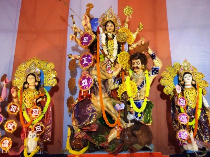 a display with a statue of lord ganeshri and other deities