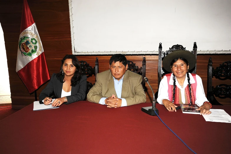 people sitting at a table with microphones in front of them