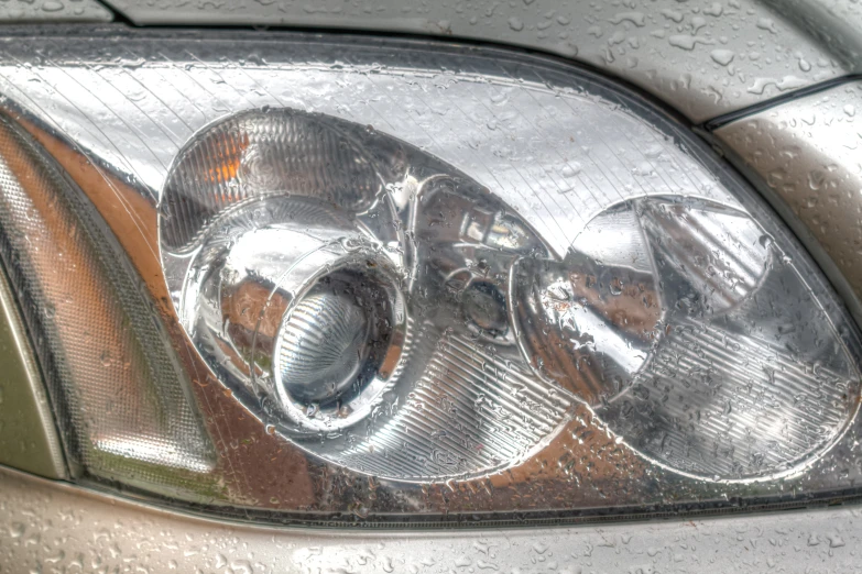 the front view of a car that has been parked in the rain