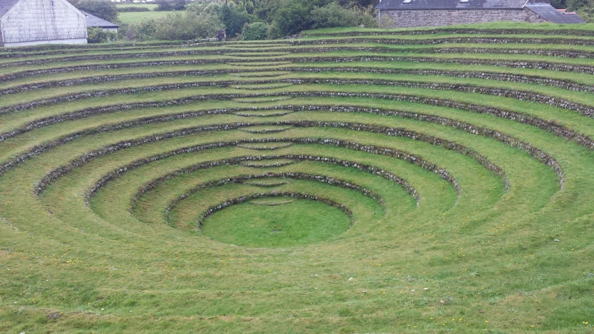 the circular cut out lawn is near two buildings