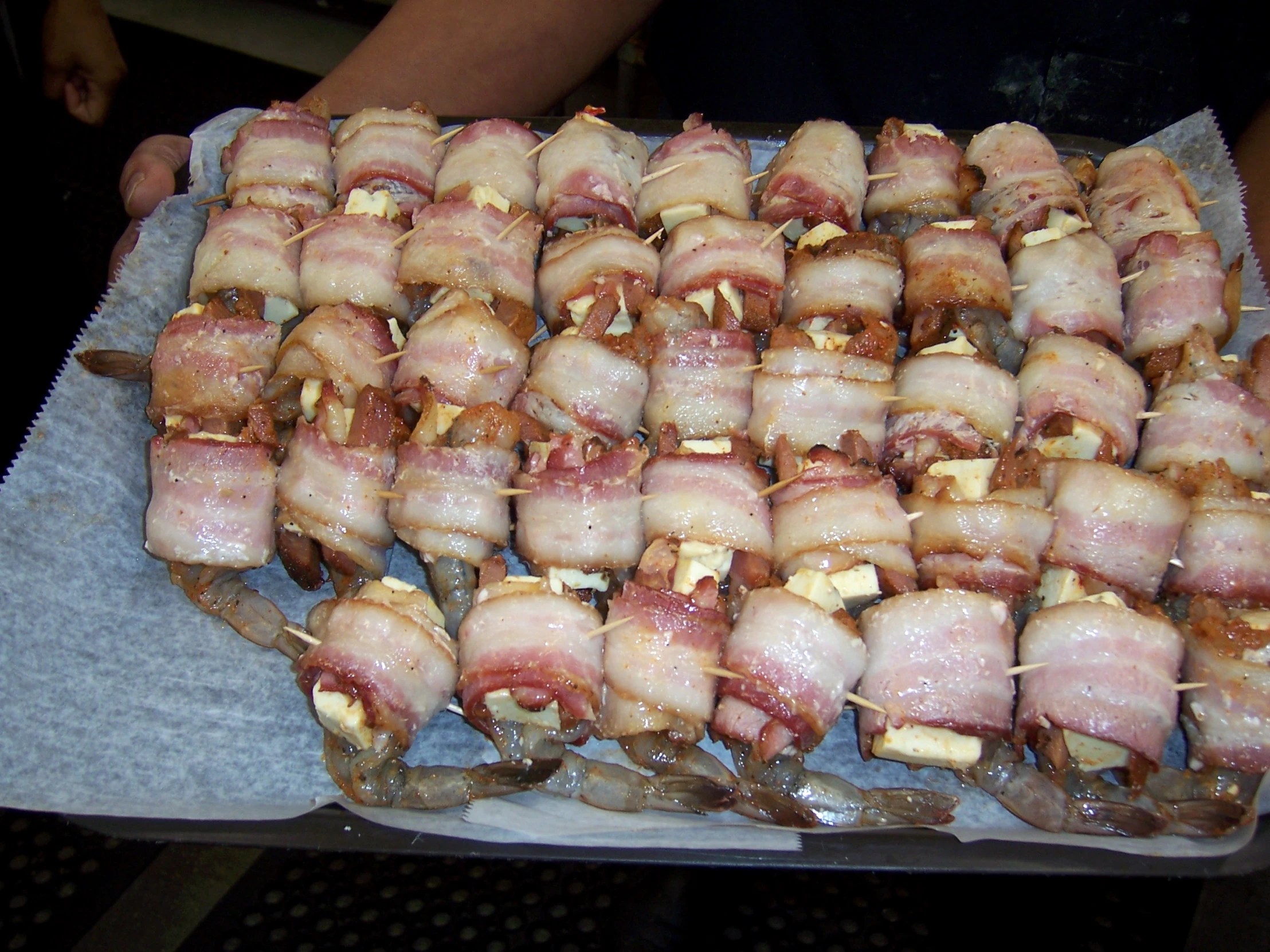 a bunch of meat wrapped in bacon and sitting on top of each other