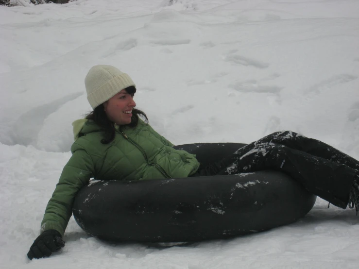 the young woman is enjoying her time laying in the snow