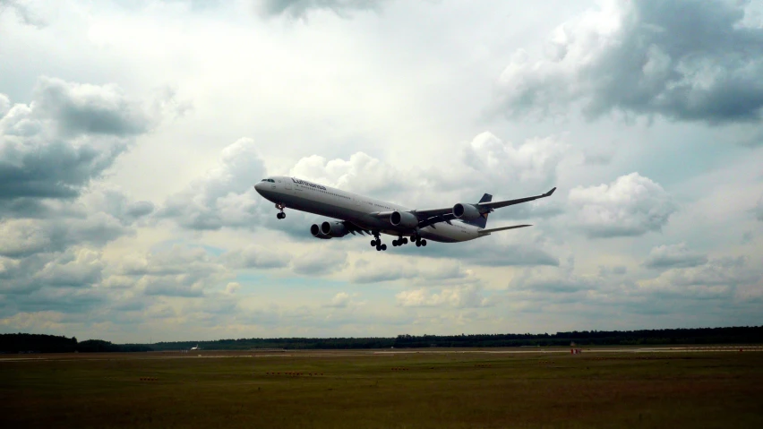 a big jumbo jet taking off with wheels in the air