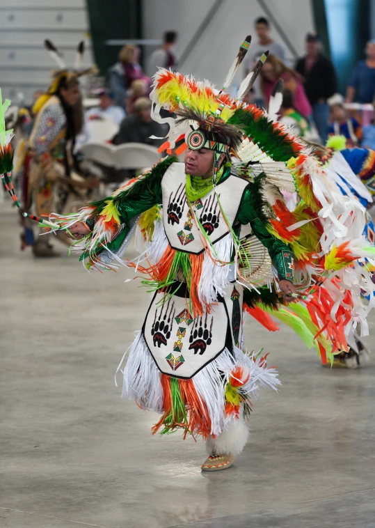 a woman wearing head dress walking on concrete