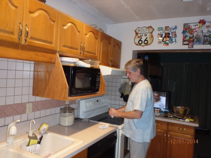 a person using a device in a kitchen