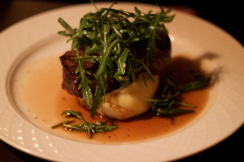 small food item sitting on a plate with dressing