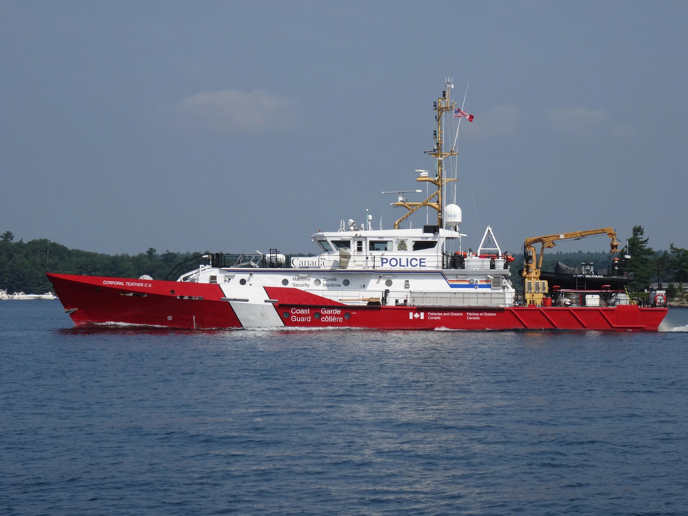 red and white patrol boat moving through the water