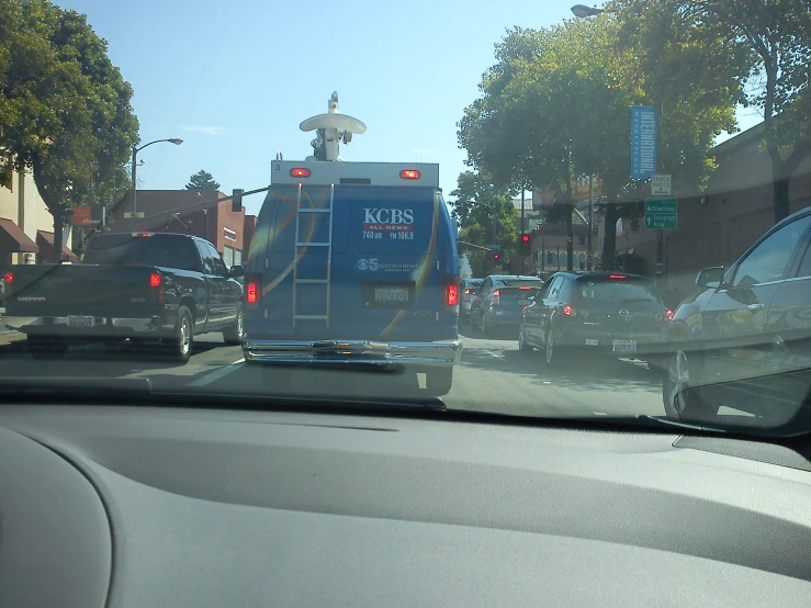 a street scene with a city bus on the road and traffic lights