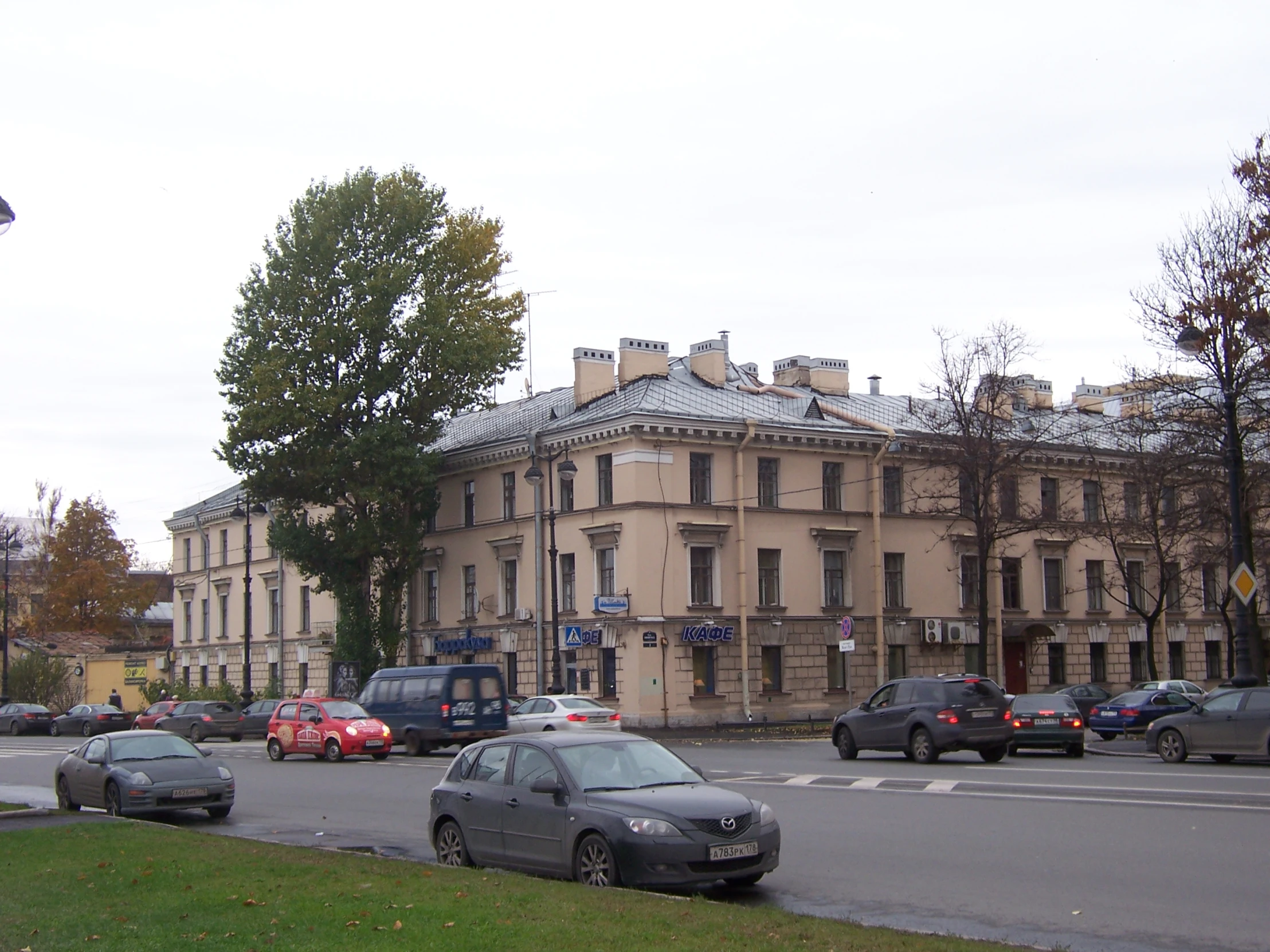 there are many cars in this street with tall buildings