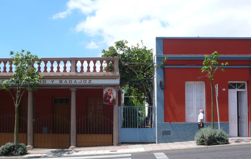 a street that has buildings and bushes in the front