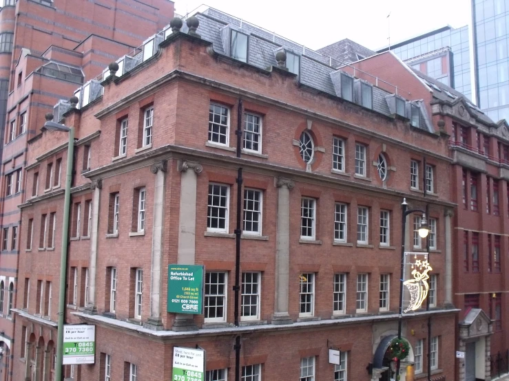 an old brick building with many windows and a street light