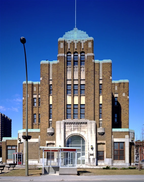 a brown and brick building with an entry way and windows