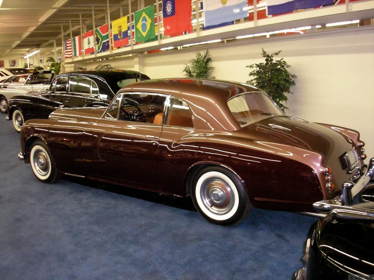 a row of classic cars are on display