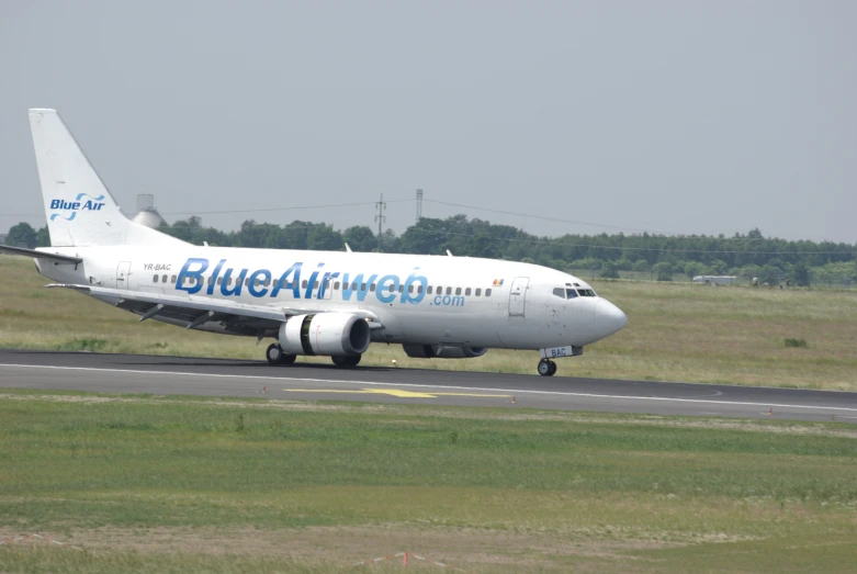 a jumbo jet parked on the runway on a cloudy day