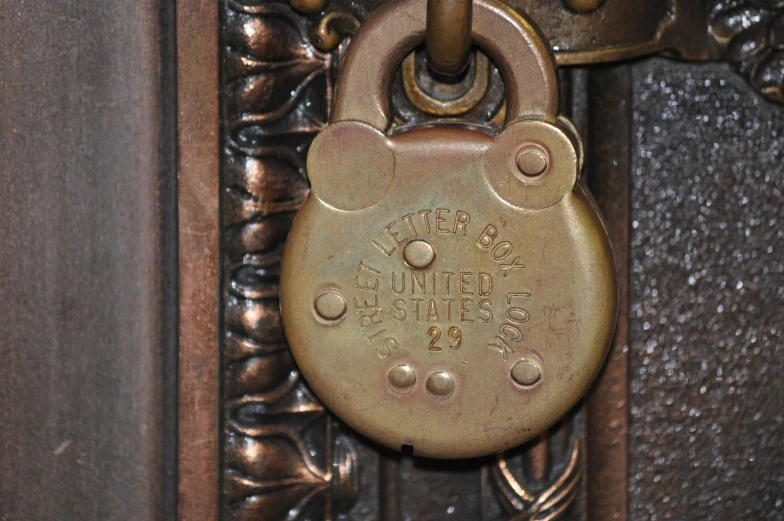 an old ss padlock on the side of a building