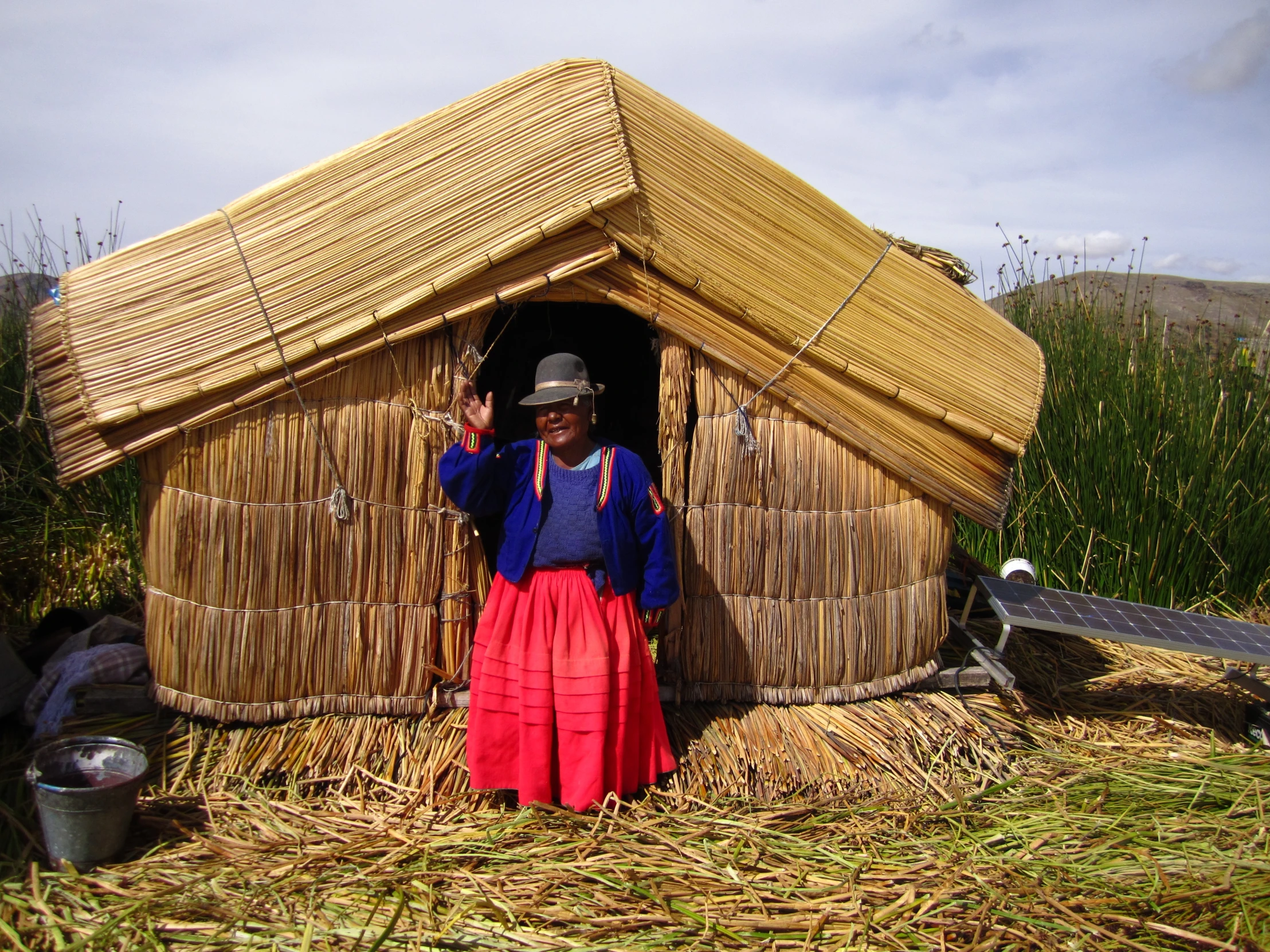 a person that is outside of a small hut