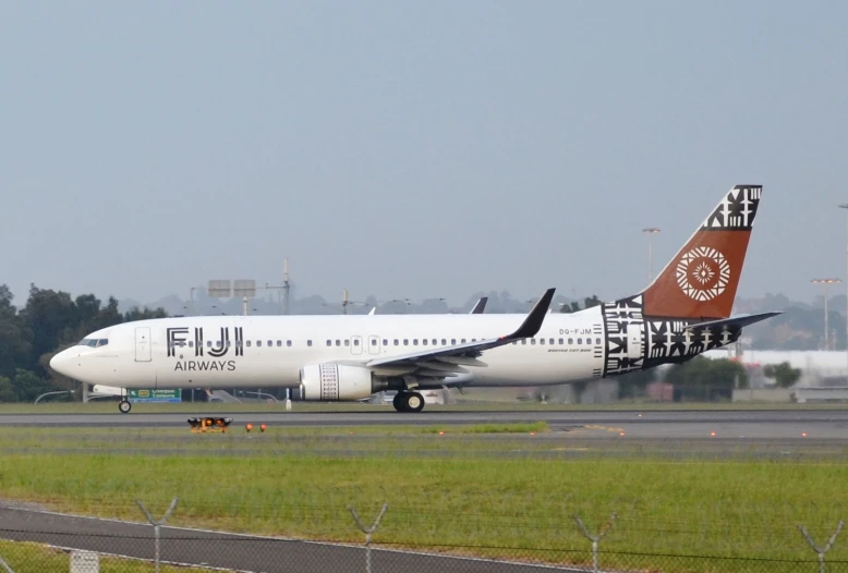 large jet airplane parked on the runway at an airport