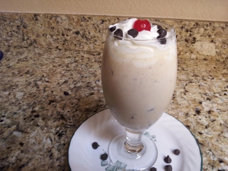 a dessert drink sitting on top of a white plate