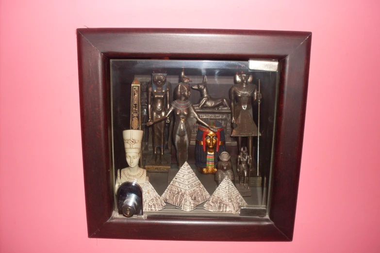 various statues are in a case inside the wall