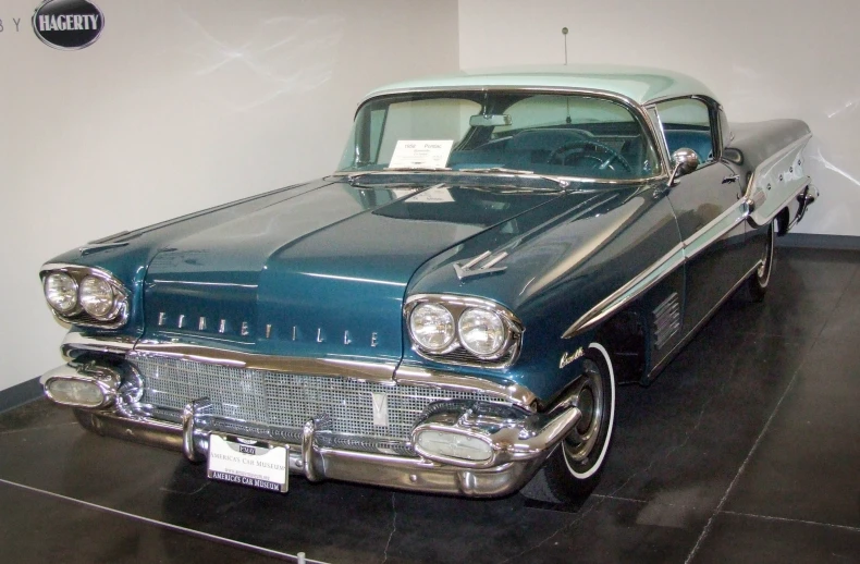 a blue and silver car sitting on top of a hard surface