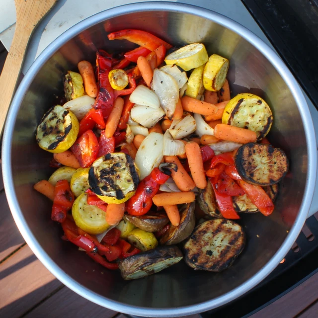 a large silver pot filled with lots of vegetables