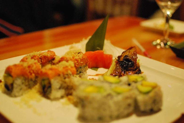 there is sushi, rice and other appetizers on the plate