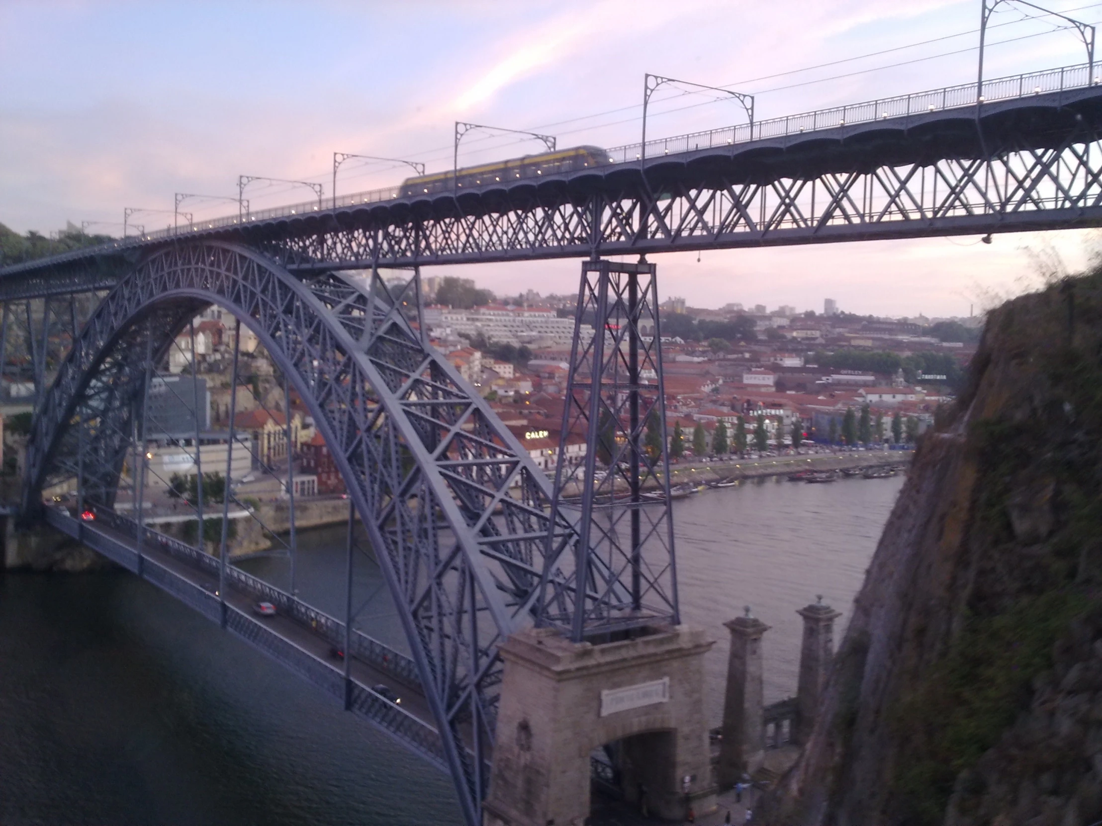 an overhead bridge in a city with water under it