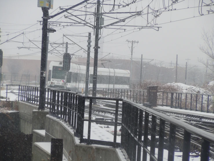 a train traveling down tracks in the snow