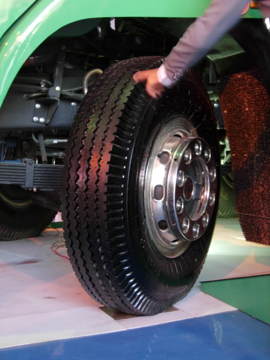 a man is changing the spokes on an all steel tractor