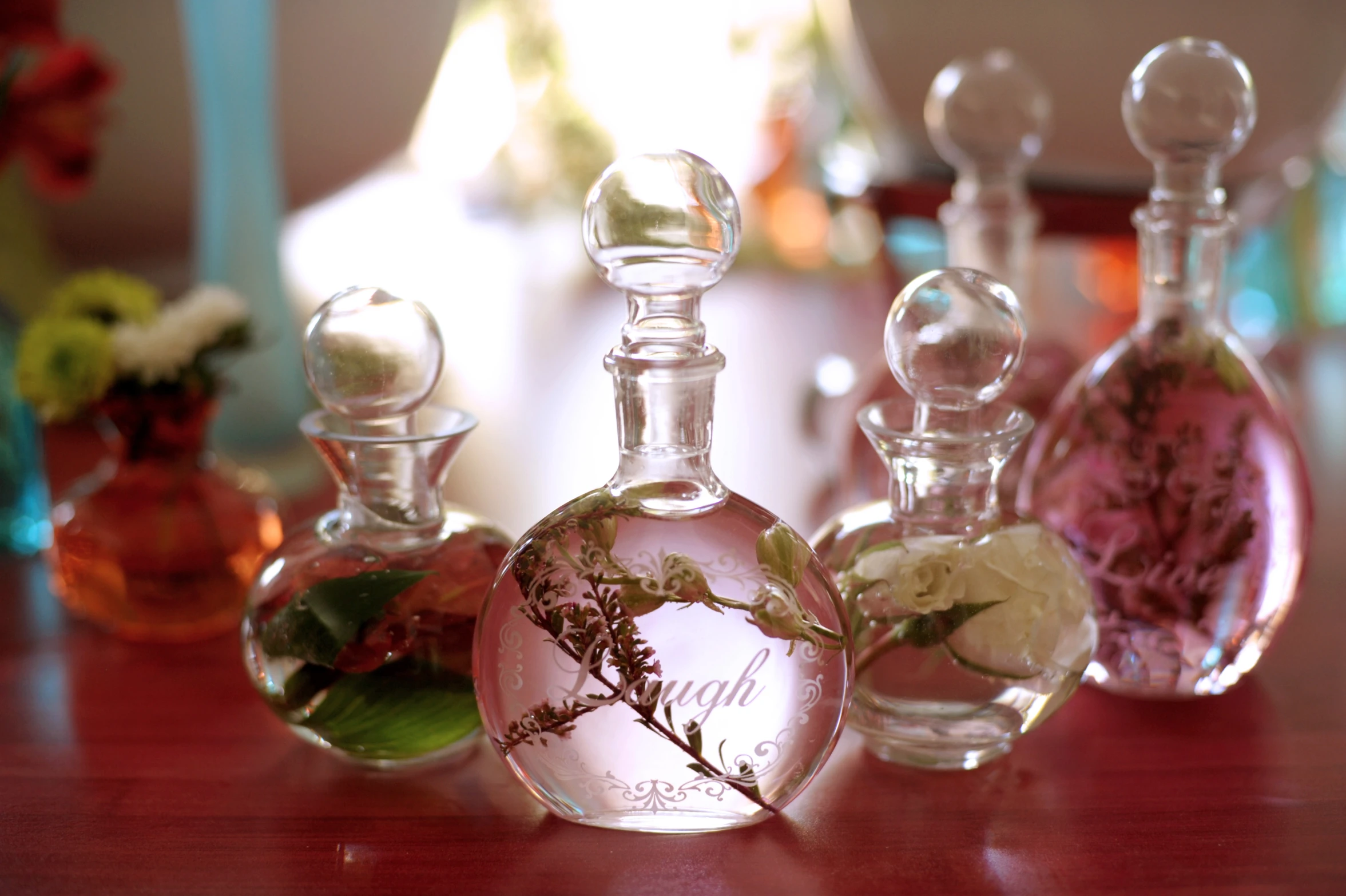 a collection of different colored bottles that are on a table