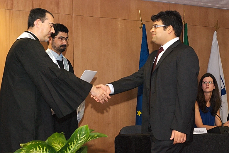 a couple of people shaking hands over a table