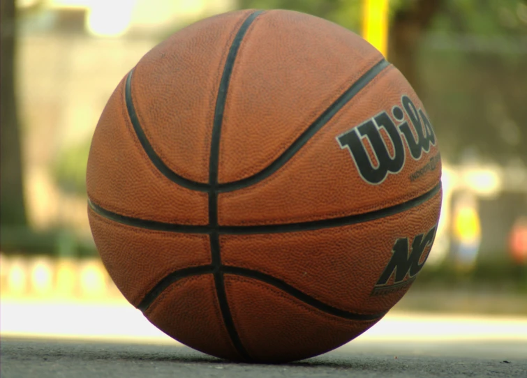 a basketball sits on the ground with no markings