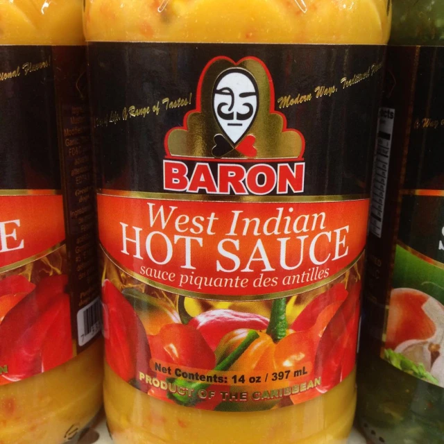 some jars of  sauce sitting on the shelf
