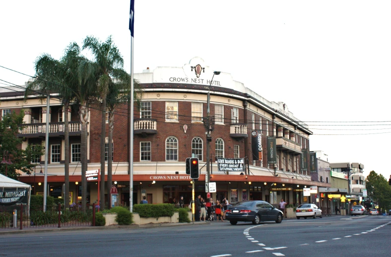 a city street lined with tall buildings and palm trees