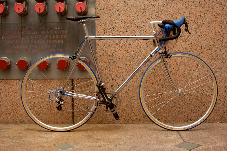 a bicycle is parked in front of a red and brown wall