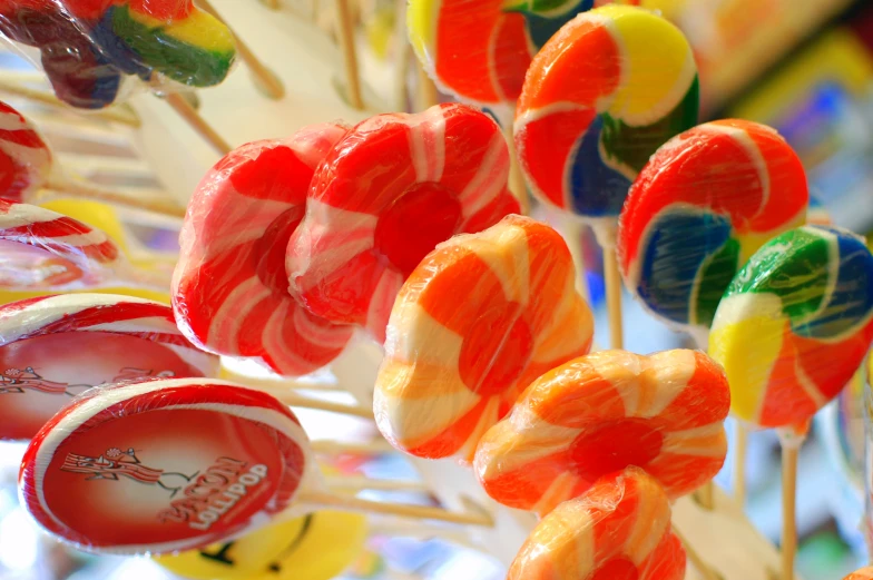 many colorful candies and lollipops are arranged in the shape of candy bars