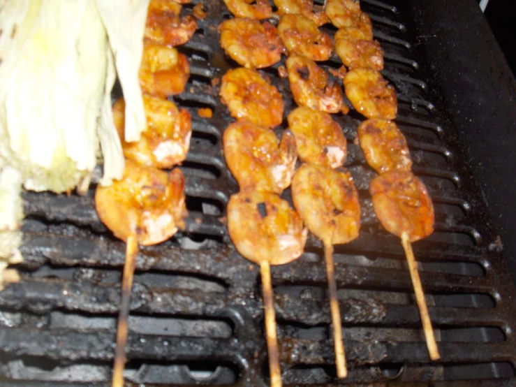 food items being cooked on the grill with tongs