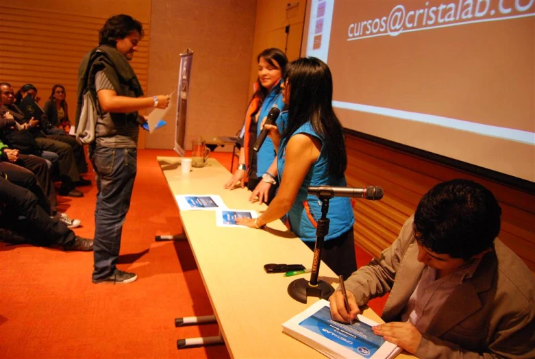 a group of people at a conference having a conversation